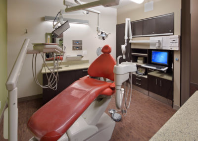 Dental exam room with red chair at Asprakis & Danti Dentistry